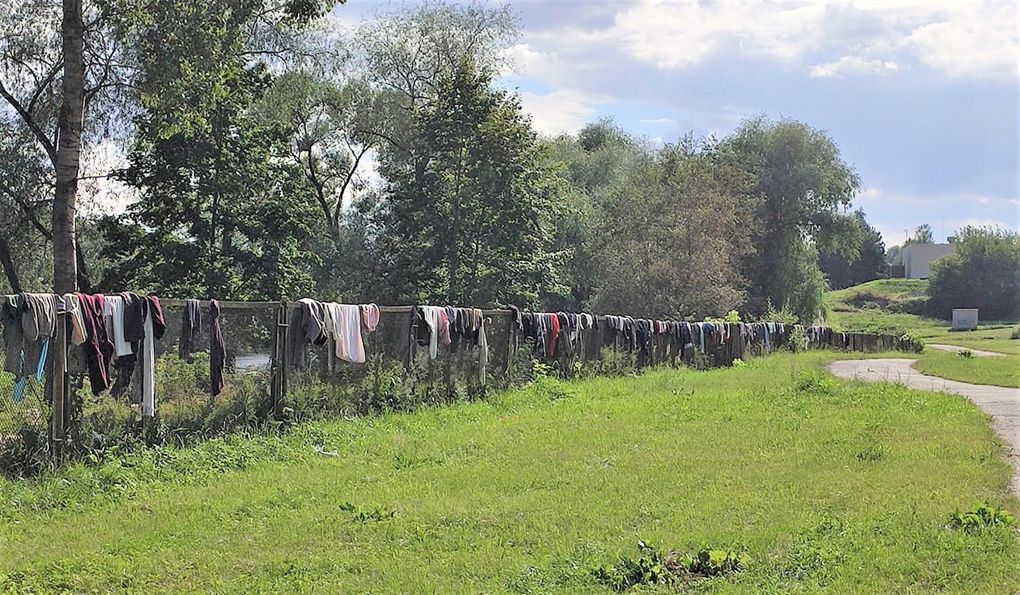 Rūbai ant tvoros – labdara ar šiukšlės? / Tvoros mieste palei upę ne sykį buvo nukabintos dėvėtais rūbais.